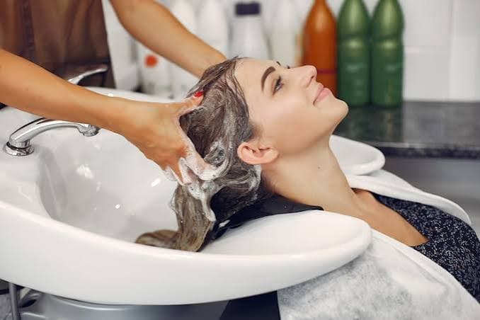 Salon interior with stylist and client
