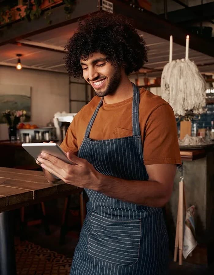 Local business owner managing reviews on a tablet