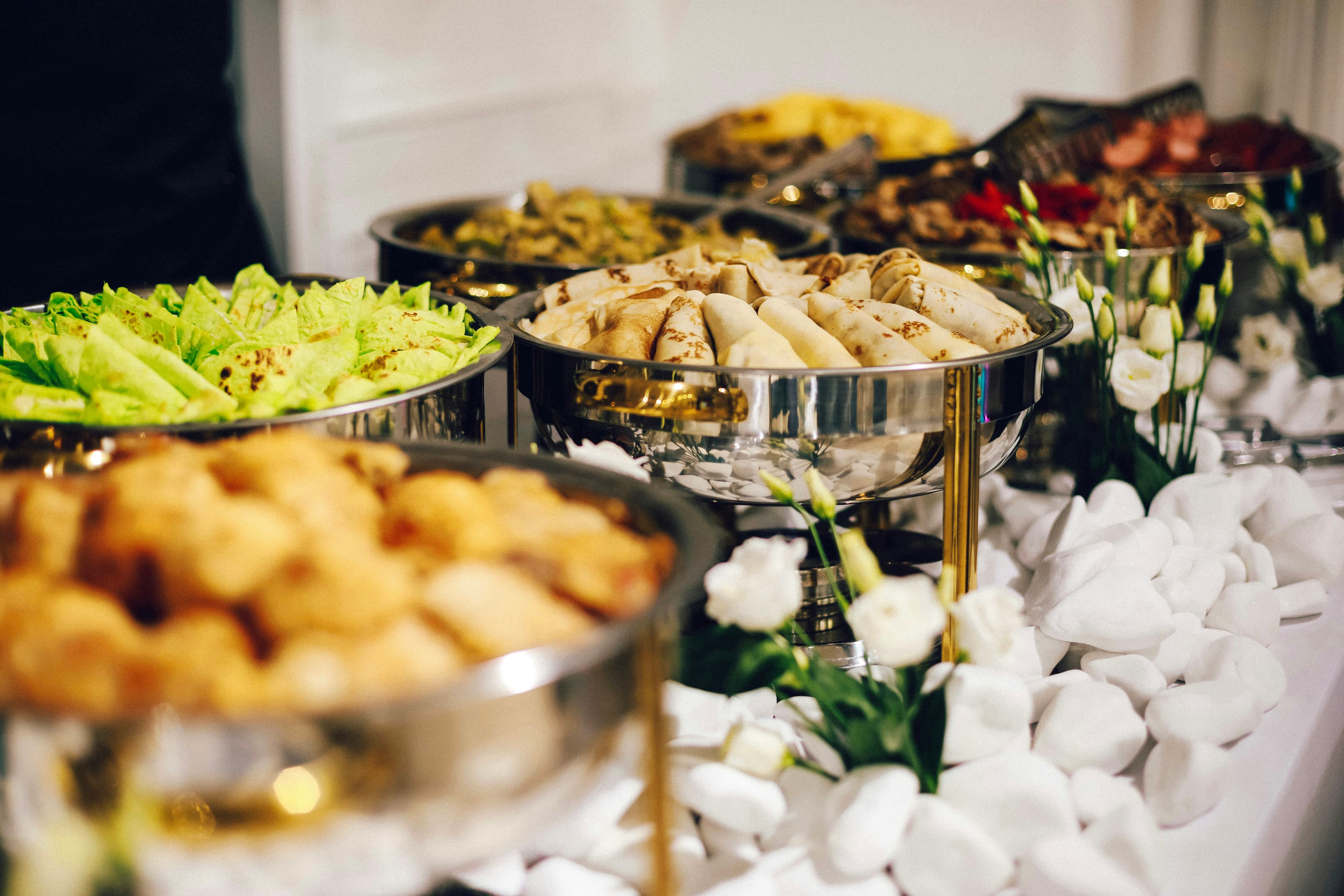 Catered buffet table with silver chafing dishes