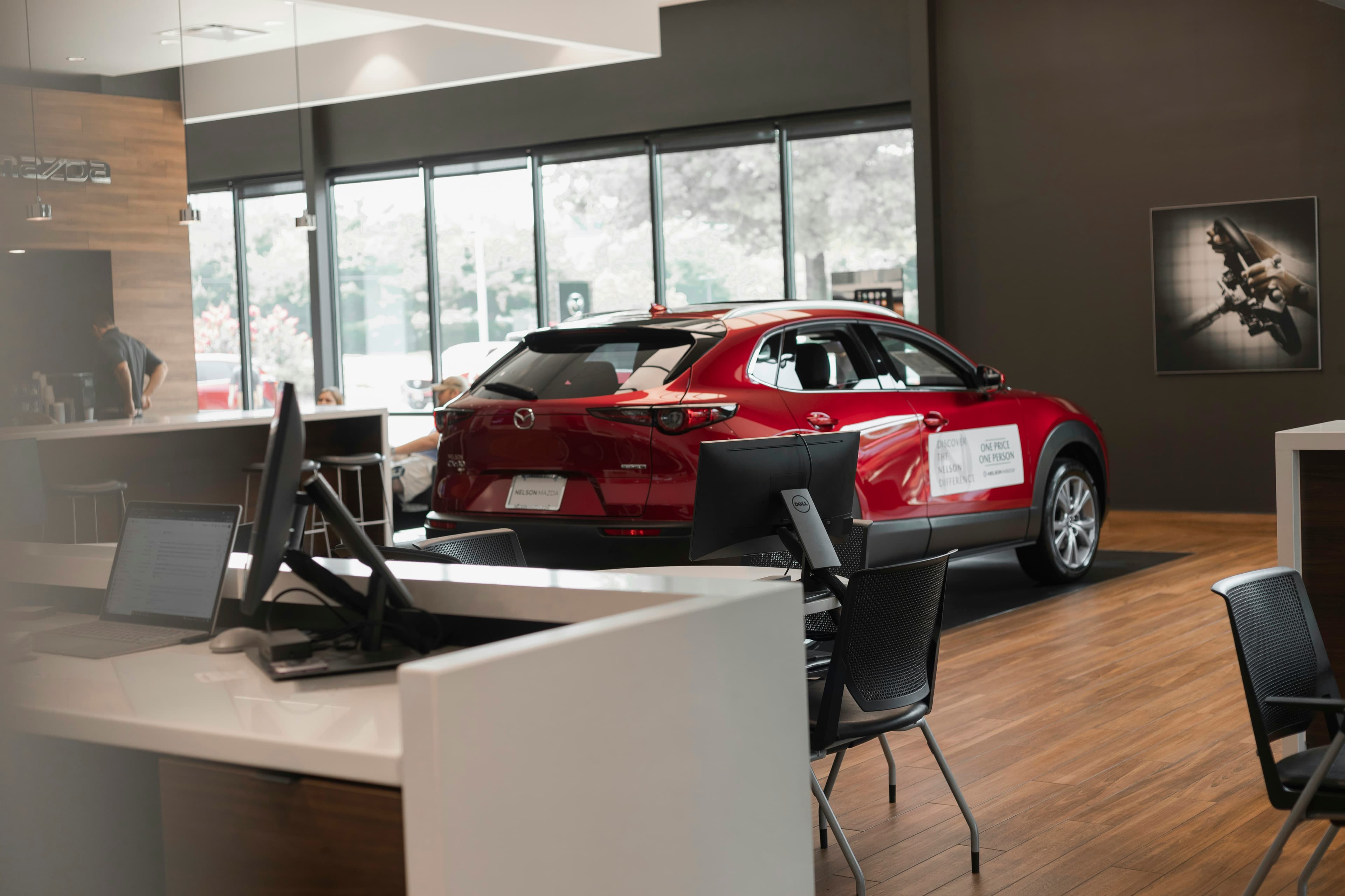Red car on display in a bright showroom
