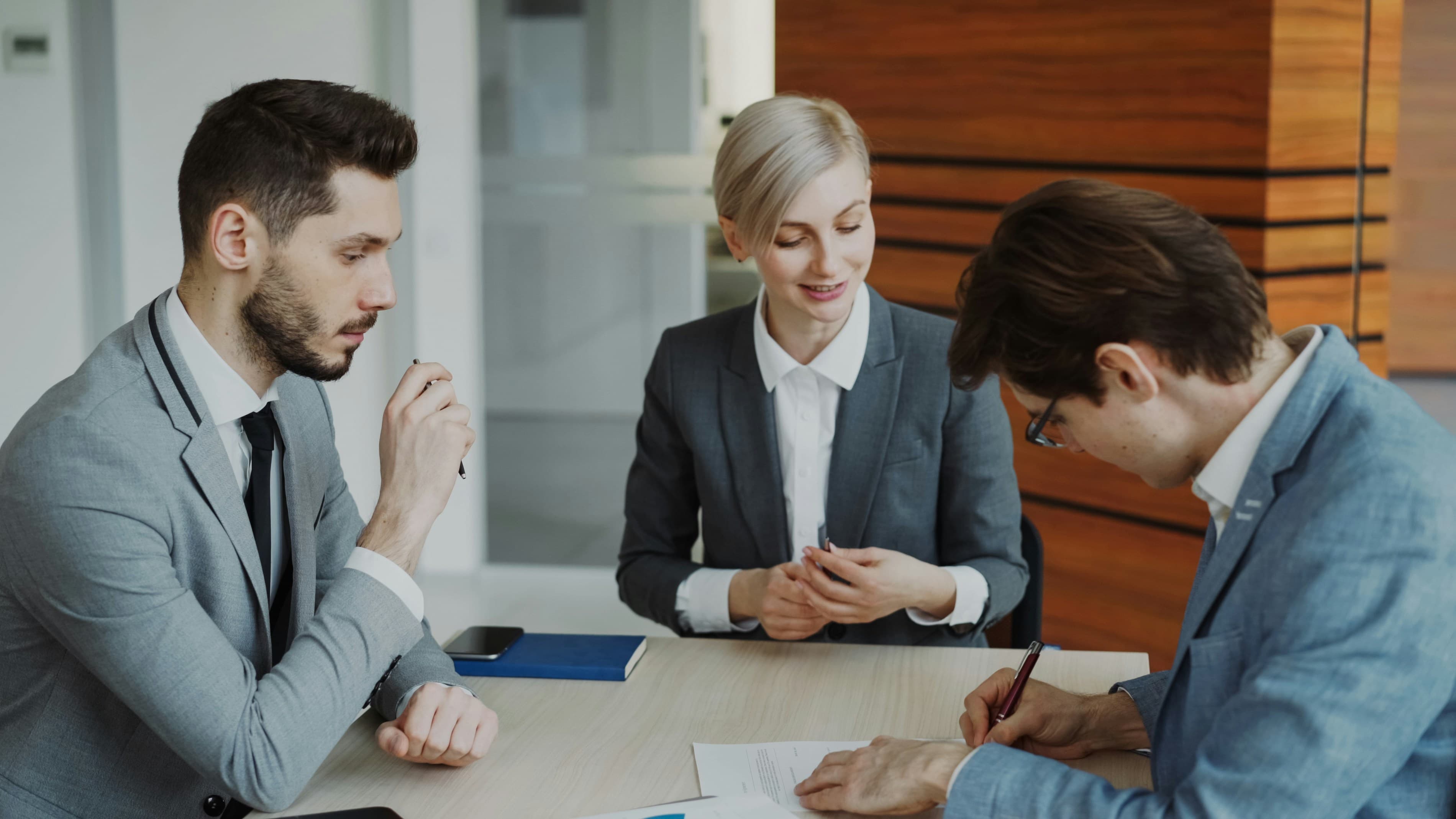 Lawyer explaining a contract to clients in an office